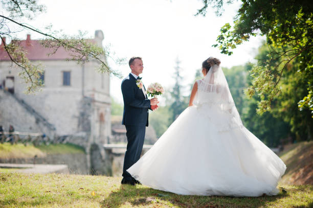 istock Fantastic wedding couple posing on the hill with a marvellous view at an ancient castle. 836469276