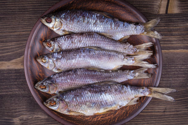 istock Dry fish on a wooden background 836473664