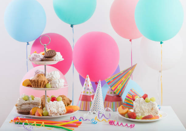istock Birthday celebration with cake and colorful balloons 836473834