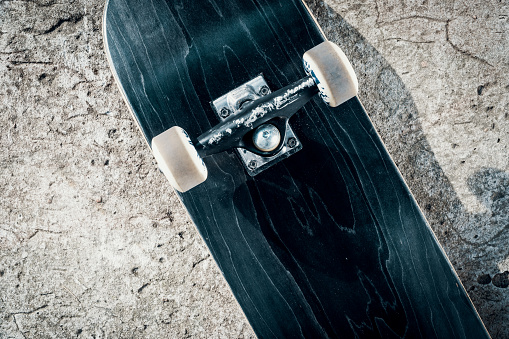 Black skateboard isolated on a concrete background in skatepark