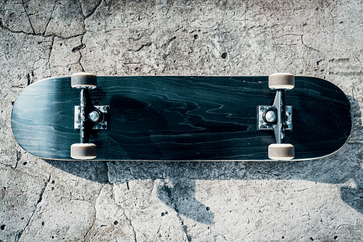 Black skateboard isolated on a concrete background in skatepark