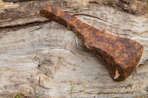 istock Old rusty ax on a wooden background. 836479326