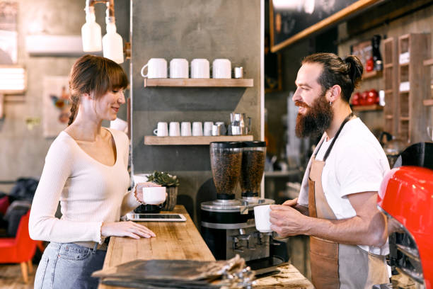 istock Staff Serving Customer In Busy Coffee Shop 836482390
