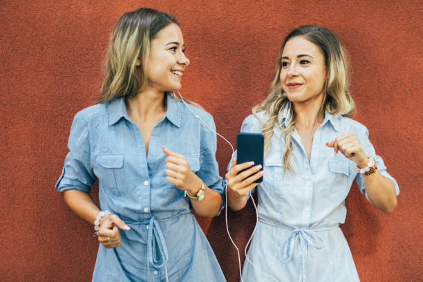 istock Twins listening to music 836486642