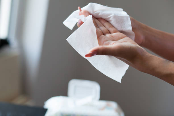 istock Clean hands with wet wipes, blurred package in background 836487118