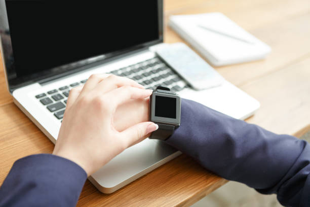 istock Female using smart watch at workplace, close up, side view, 836490274