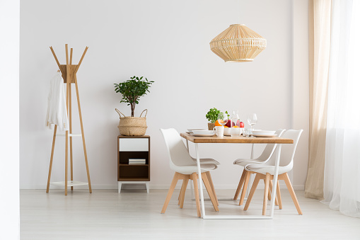 Simple stylish scandinavian dining room in minimalist white apartment