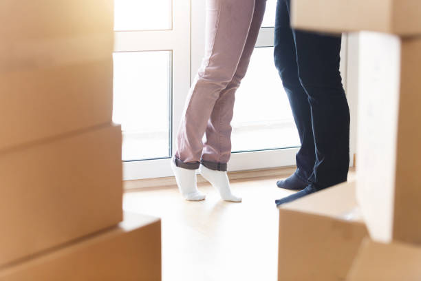 istock Happy young married couple with Unpackaged boxes holding new flat keys 836494890