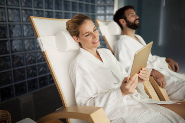 istock Couple enjoying spa treatments and relaxing with tablet 836495152