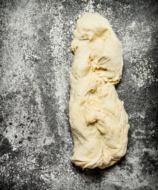 istock Dough background. A piece of fresh pastry. 836498714