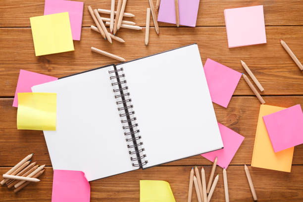 istock Top view of blank notepad on wooden office desk 836499038