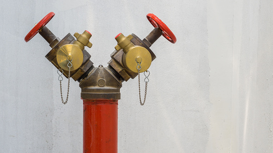 Fire hose nozzle on the wall background.Security fire system industry.