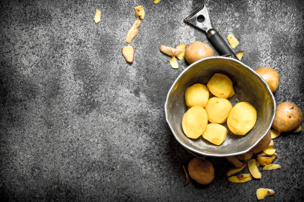 istock Fresh shelled organic potatoes in the old bucket. On rustic background. 836505930