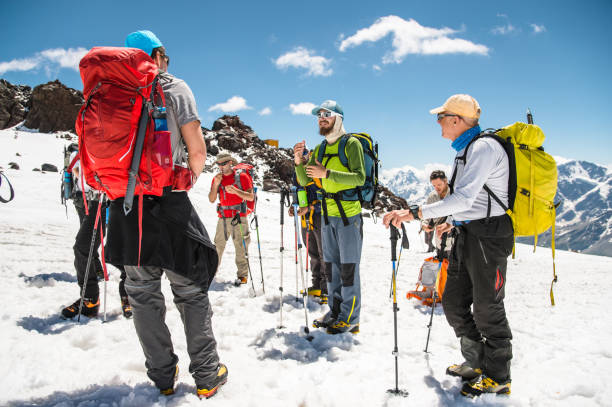 istock A team of climbers led by a guide discusses the upcoming ascent 836507344