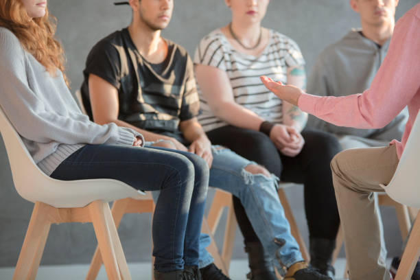 Rebellious youth at psychotherapy Rebellious youth being treated at a psychotherapy meeting group therapy photos stock pictures, royalty-free photos & images