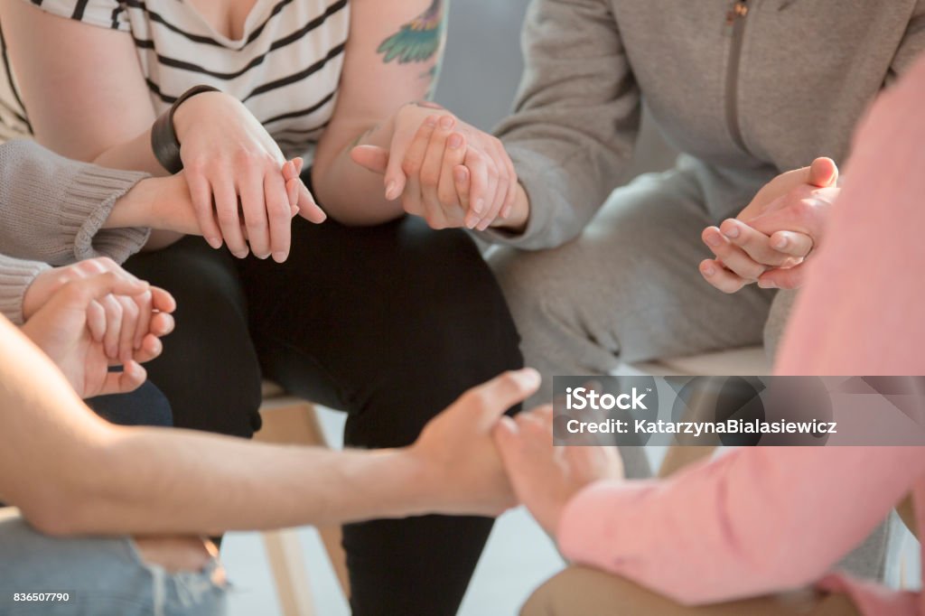 Teenagers receiving help Rebellious teenagers receiving help from psychology specialist, psychotherapy concept Alcoholics Anonymous Stock Photo