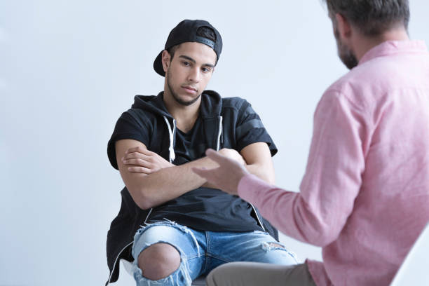 Teenager deep in though Teenager deep in thought during a therapy session rebellion stock pictures, royalty-free photos & images