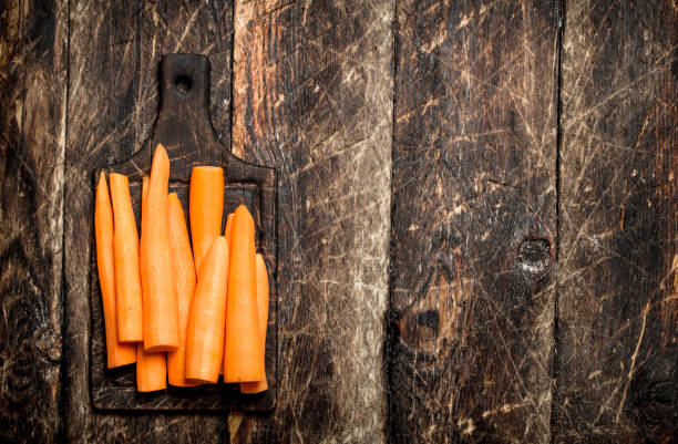 carote fresche sbucciate su un tagliere. sul vecchio tavolo di legno. - 5552 foto e immagini stock