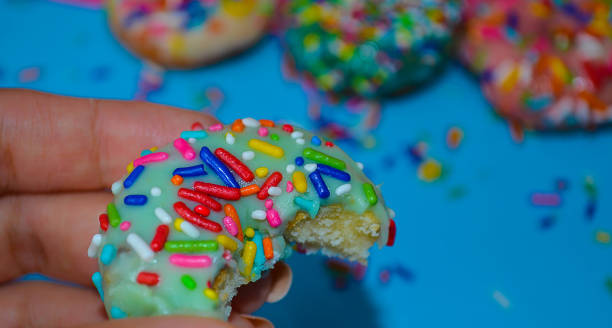 istock Woman holding a bitten donut, close up 836515848