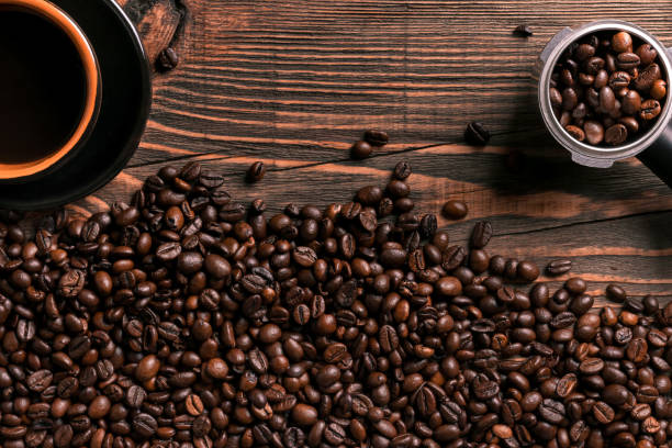 istock Coffee cup and beans frame on wooden table 836518274