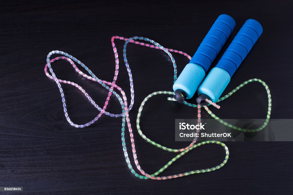 Blue skipping rope Blue skipping rope with black background. Activity Stock Photo