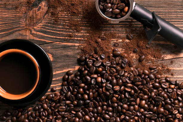 istock Coffee cup and beans frame on wooden table 836518788