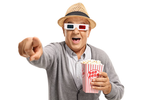 istock Mature man with popcorn and 3D glasses pointing and laughing 836519072