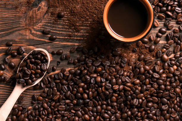 istock Coffee cup and beans frame on wooden table 836522580