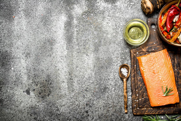 istock Raw fish. Salmon fillet with herbs and spices. On rustic background. 836522732