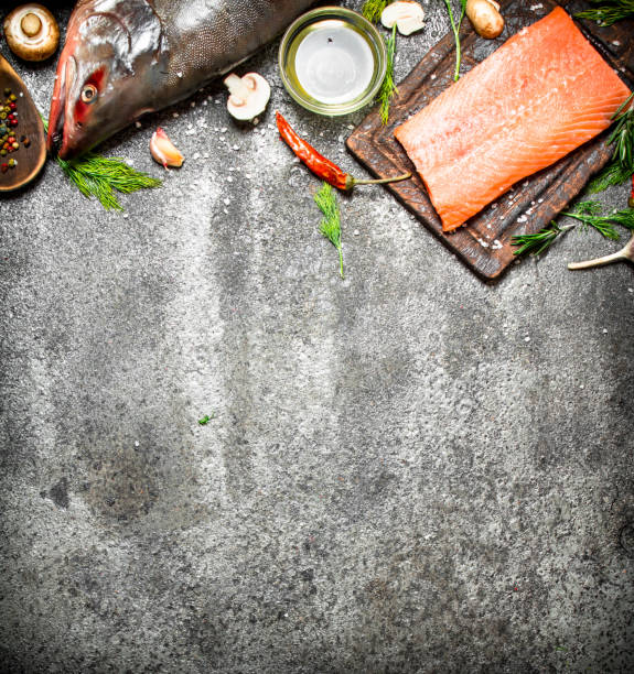istock Raw fish. Salmon fillet with herbs and spices. On rustic background. 836523336