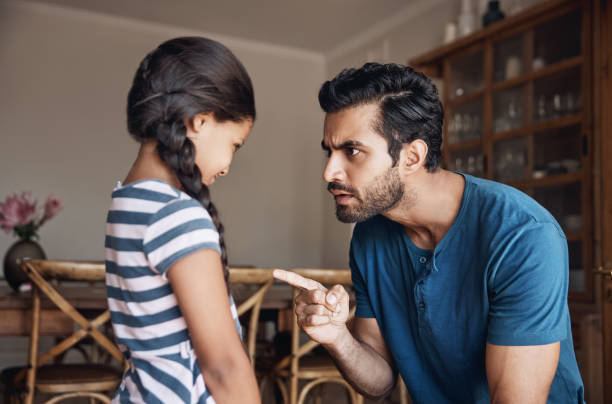 That is very naughty! Shot of a father disciplining his daughter at home scolding stock pictures, royalty-free photos & images
