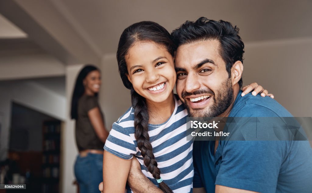 Dad hugs are the best kind of hugs Shot of a happy father and daughter spending some quality time together at home Family Stock Photo