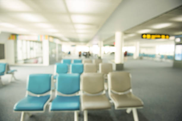 istock Blurred image of empty chairs for passengers while waiting for departure inside the airport building. 836527716