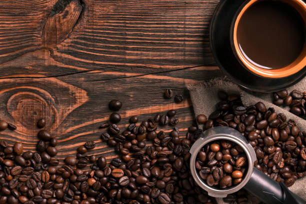 istock Coffee cup and beans frame on wooden table 836528500