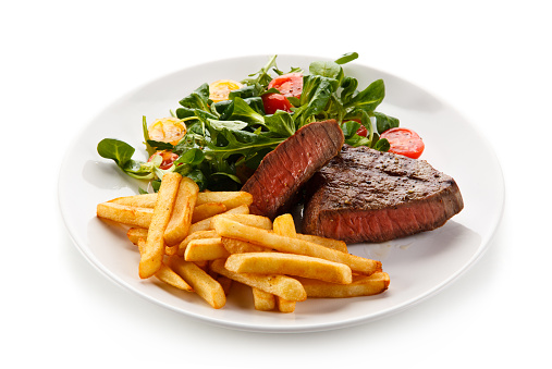 Grilled steak with chips and vegetable salad
