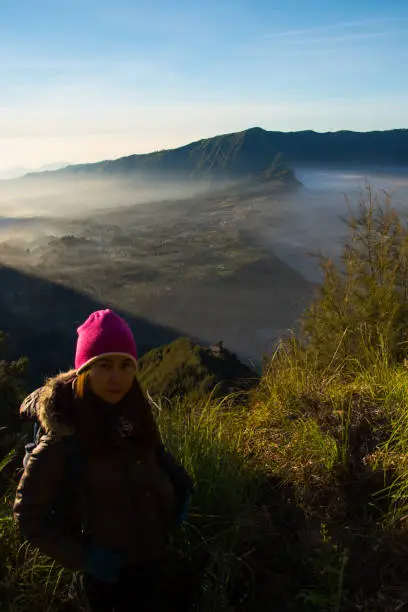 Woman tourism at Kingkong Hill view point enjoy travel see sunrise view at Mount Bromo volcano,  JAVA, INDONESIA.
