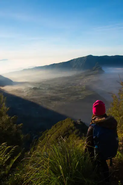 Woman tourism at Kingkong Hill view point enjoy travel see sunrise view at Mount Bromo volcano,  JAVA, INDONESIA.