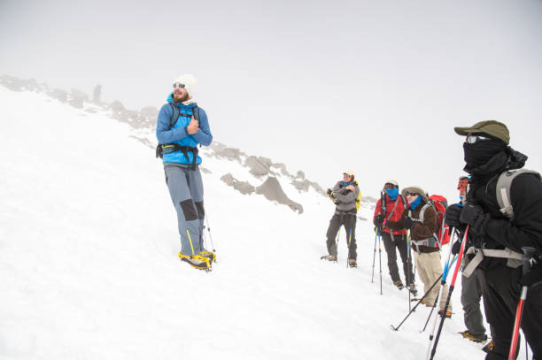 istock A team of climbers led by a guide discusses the upcoming ascent 836535456
