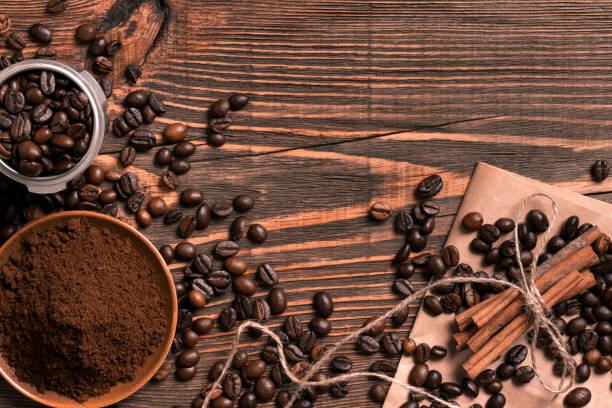 istock Coffee beans, cinnamon sticks and ground coffee on rustic wooden 836538662