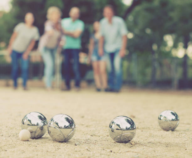 istock people playing petanque at leisure 836539076