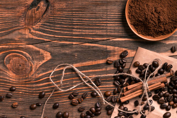 istock Coffee beans, cinnamon sticks and ground coffee on rustic wooden 836539362