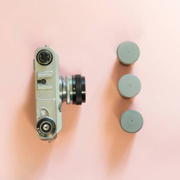 istock Old retro camera with three box for film on pink background. 836539878