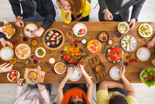 istock People eat healthy meals at served table dinner party 836543778