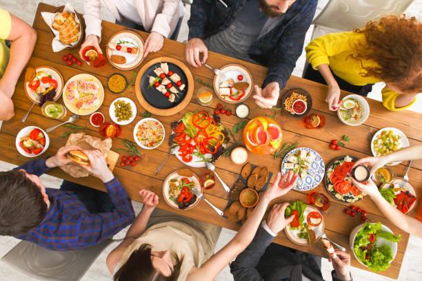 istock People eat healthy meals at served table dinner party 836543952