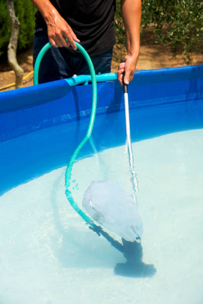 istock young man cleaning a portable swimming pool 836544022