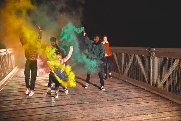 istock Friends enjoying with smoke bomb on bridge 836547342