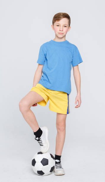 istock Boy in casual with soccer ball at white studio background 836548260