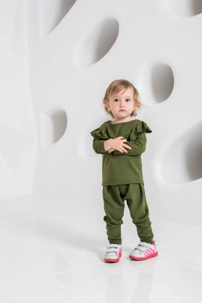 istock Year-old child standing near white wall in studio 836548334