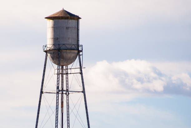 istock Old abandoned water tower against a cloudy sky. 836549074