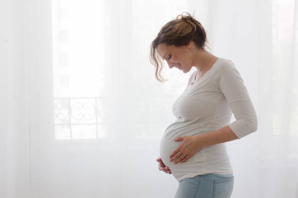istock Pregnant woman touching belly 836554384